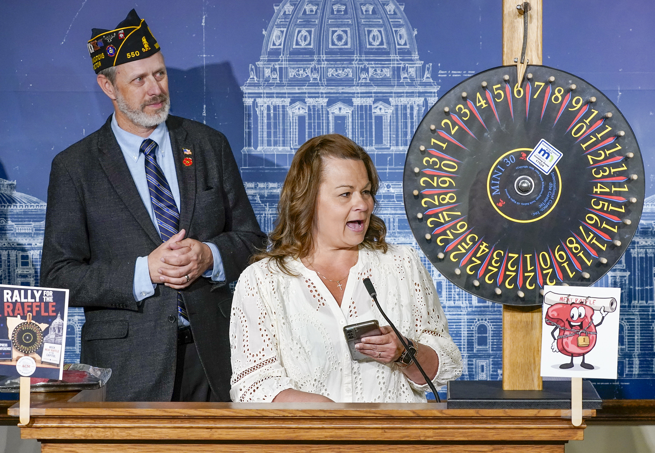 Amanda Jackson, gambling manager for the Spring Lake Park Lions Club and president of Allied Charities of Minnesota, calls out the winning number for a mock meat raffle at a May 14 “Rally for the Raffle” press conference Thursday urging immediate passage of the Meat Raffle Modernization Act. (Photo by Andrew VonBank)